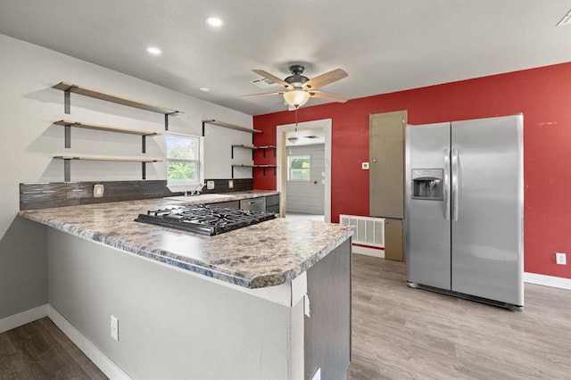 4504 N Grove Ave, Warr Acres, OK 73122 - kitchen featuring appliances with stainless steel finishes, open shelves, light wood-style flooring, a peninsula, and ceiling fan