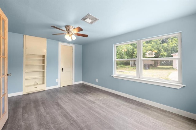 4504 N Grove Ave, Warr Acres, OK 73122 - unfurnished bedroom with dark wood-style flooring and a ceiling fan