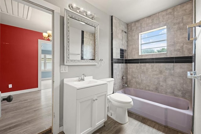 4504 N Grove Ave, Warr Acres, OK 73122 - bathroom with wood finished floors, vanity, and shower / washtub combination