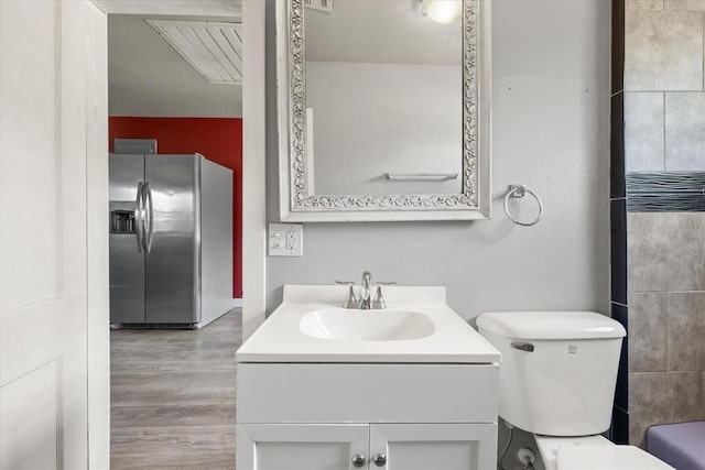4504 N Grove Ave, Warr Acres, OK 73122 - full bathroom with vanity and wood finished floors