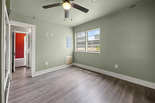 4504 N Grove Ave, Warr Acres, OK 73122 - unfurnished room with wood finished floors, a ceiling fan, and electric panel