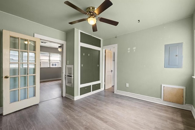 4504 N Grove Ave, Warr Acres, OK 73122 - spare room with electric panel, a ceiling fan, and wood finished floors