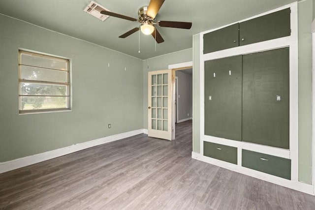 4504 N Grove Ave, Warr Acres, OK 73122 - unfurnished bedroom with wood finished floors and ceiling fan