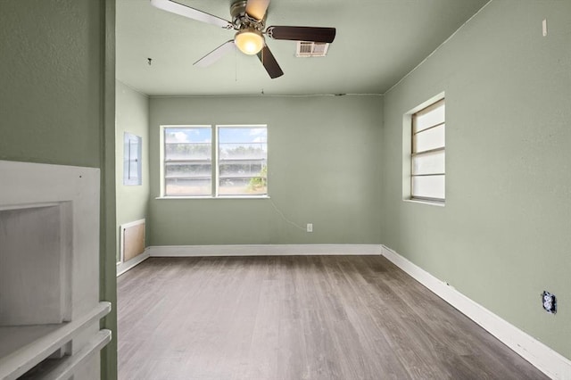 4504 N Grove Ave, Warr Acres, OK 73122 - unfurnished living room with wood finished floors and a ceiling fan