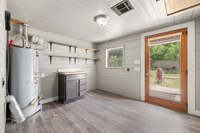 4504 N Grove Ave, Warr Acres, OK 73122 - kitchen with water heater, open shelves, light wood-style flooring, and wood ceiling