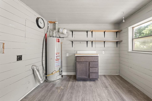 4504 N Grove Ave, Warr Acres, OK 73122 - below grade area featuring water heater, wood finished floors, and wooden walls