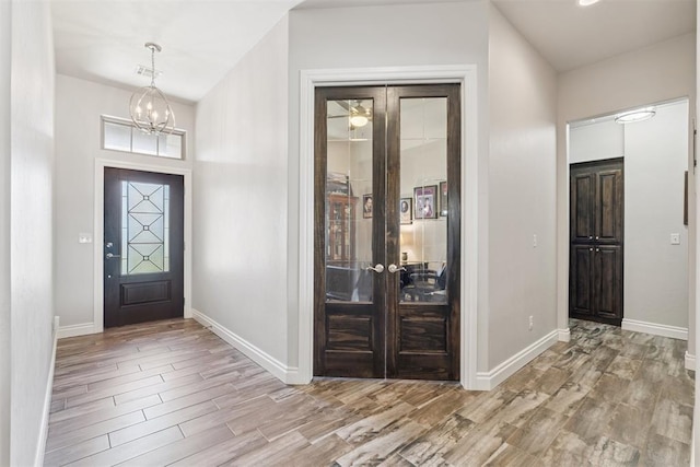 12505 Shady Gln, Choctaw, OK 73020 - foyer entrance featuring wood finished floors, french doors, and a chandelier