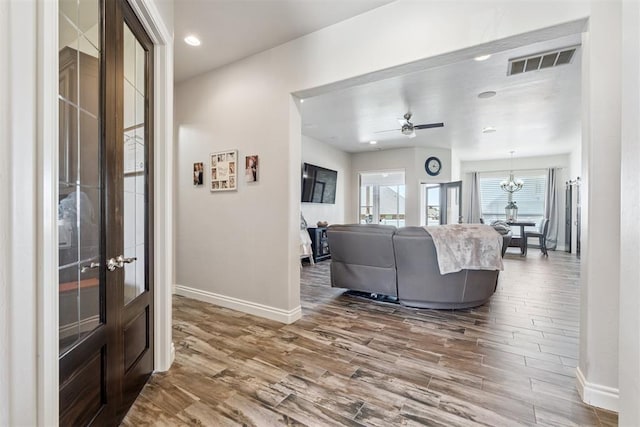 12505 Shady Gln, Choctaw, OK 73020 - living area featuring wood finished floors, french doors, a chandelier, and ceiling fan