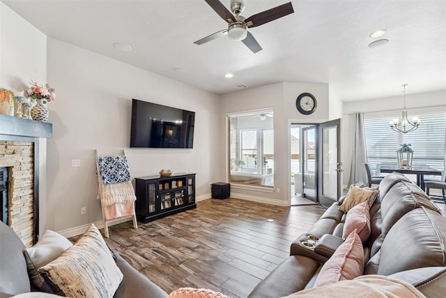 12505 Shady Gln, Choctaw, OK 73020 - living room with a ceiling fan, wood finished floors, recessed lighting, a chandelier, and a stone fireplace
