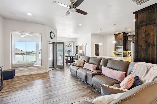 12505 Shady Gln, Choctaw, OK 73020 - living area featuring a chandelier, ceiling fan, recessed lighting, and wood finished floors