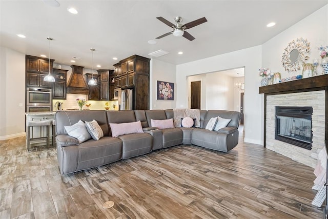 12505 Shady Gln, Choctaw, OK 73020 - living room featuring light wood finished floors, recessed lighting, a ceiling fan, and a fireplace