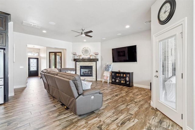 12505 Shady Gln, Choctaw, OK 73020 - living room featuring light wood finished floors, a fireplace, ceiling fan, and recessed lighting