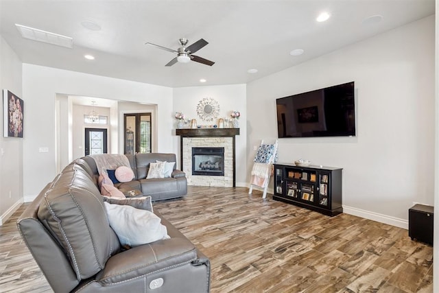 12505 Shady Gln, Choctaw, OK 73020 - living room featuring wood finished floors, a ceiling fan, recessed lighting, and a stone fireplace