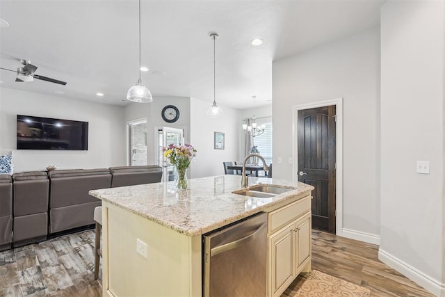 12505 Shady Gln, Choctaw, OK 73020 - kitchen with stainless steel dishwasher, cream cabinetry, light wood-style floors, an island with sink, and open floor plan