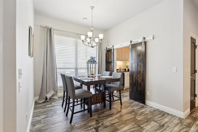 12505 Shady Gln, Choctaw, OK 73020 - dining room with a barn door, a chandelier, and wood finished floors