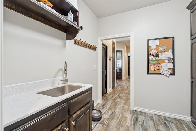 12505 Shady Gln, Choctaw, OK 73020 - laundry room with a sink and light wood-style flooring
