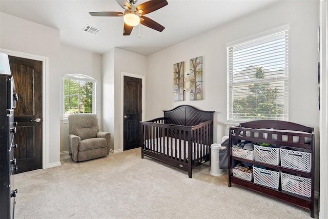 12505 Shady Gln, Choctaw, OK 73020 - carpeted bedroom with a nursery area and ceiling fan