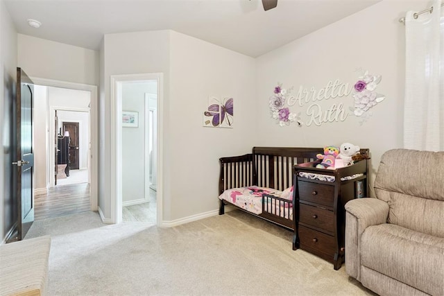 12505 Shady Gln, Choctaw, OK 73020 - bedroom featuring light colored carpet, a ceiling fan, and a crib