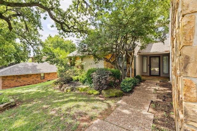 2416 Chimney Hill Ct, Edmond, OK 73034 - property entrance featuring roof with shingles and a lawn