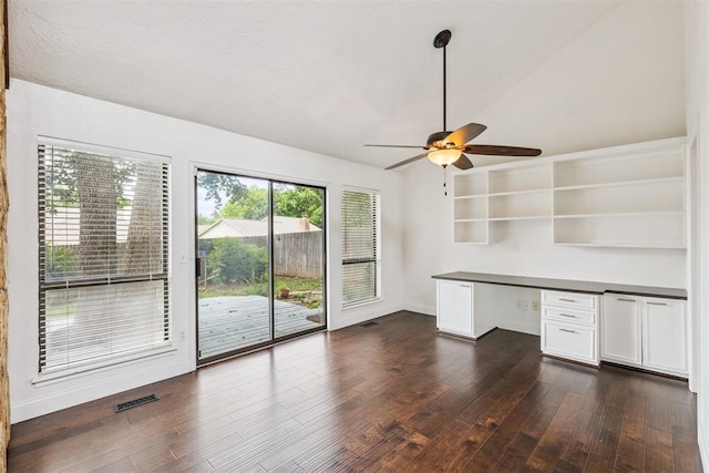 2416 Chimney Hill Ct, Edmond, OK 73034 - unfurnished office featuring built in study area, dark wood finished floors, a ceiling fan, and vaulted ceiling