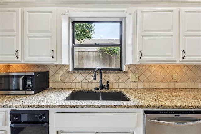 2416 Chimney Hill Ct, Edmond, OK 73034 - kitchen with appliances with stainless steel finishes, backsplash, white cabinetry, and light stone counters
