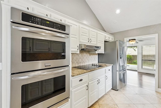 2416 Chimney Hill Ct, Edmond, OK 73034 - kitchen featuring stainless steel appliances, decorative backsplash, lofted ceiling, light tile patterned floors, and white cabinetry