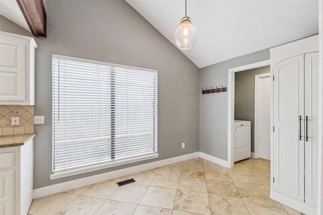 2416 Chimney Hill Ct, Edmond, OK 73034 - unfurnished dining area featuring washer / clothes dryer, vaulted ceiling, and light tile patterned floors