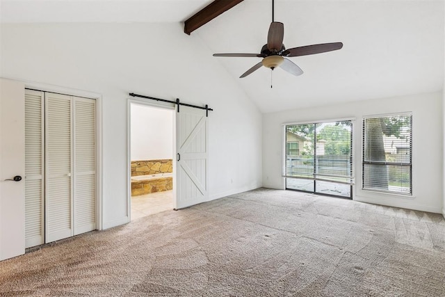 2416 Chimney Hill Ct, Edmond, OK 73034 - unfurnished bedroom with carpet, a barn door, beam ceiling, high vaulted ceiling, and ensuite bath