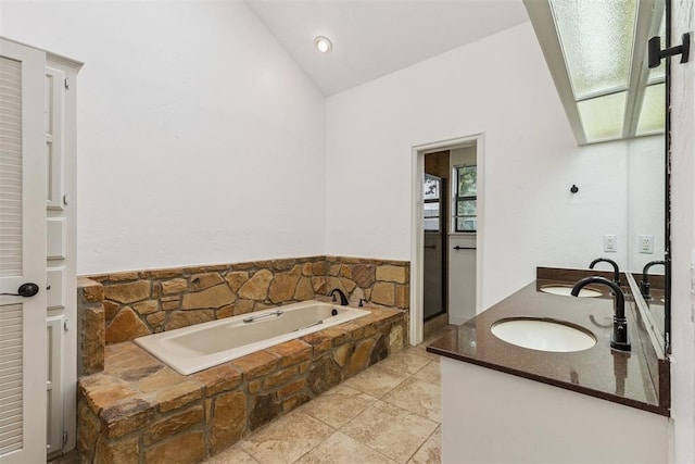 2416 Chimney Hill Ct, Edmond, OK 73034 - full bath with vaulted ceiling, double vanity, and a garden tub