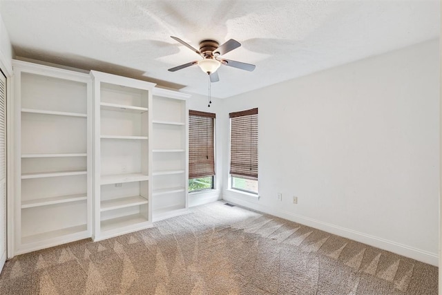2416 Chimney Hill Ct, Edmond, OK 73034 - unfurnished bedroom featuring carpet floors, a textured ceiling, and a ceiling fan