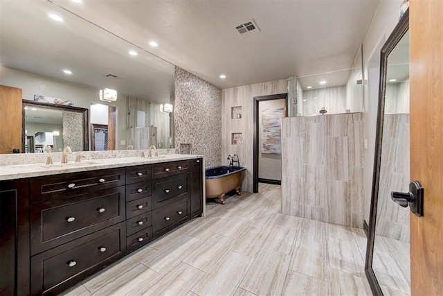 4225 Red Bud Pl, Edmond, OK 73013 - bathroom featuring a soaking tub, double vanity, a walk in shower, and recessed lighting
