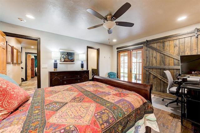 4225 Red Bud Pl, Edmond, OK 73013 - bedroom featuring wood finished floors, a barn door, recessed lighting, and ceiling fan