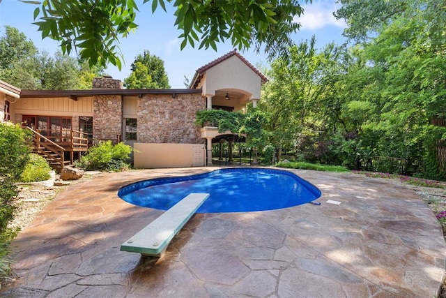 4225 Red Bud Pl, Edmond, OK 73013 - swimming pool featuring a diving board, a patio area, and stairway
