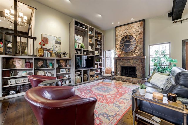 4225 Red Bud Pl, Edmond, OK 73013 - living room with hardwood / wood-style floors, a stone fireplace, a chandelier, and recessed lighting