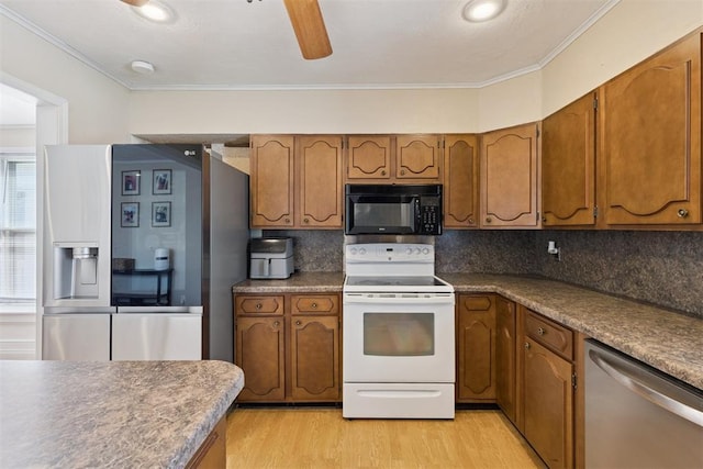 1623 W Washington Ave, Guthrie, OK 73044 - kitchen featuring stainless steel appliances, brown cabinetry, decorative backsplash, and crown molding