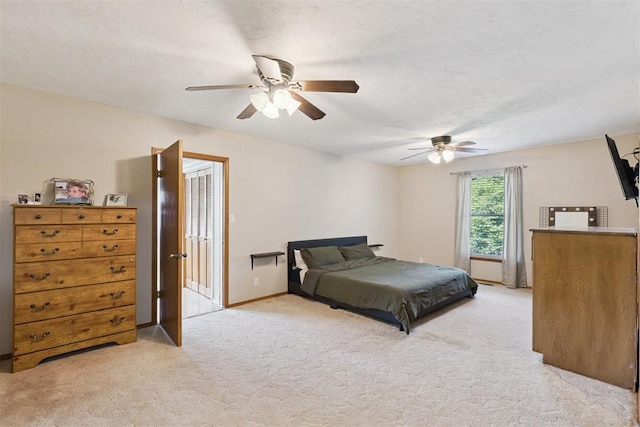 1623 W Washington Ave, Guthrie, OK 73044 - bedroom with light colored carpet and a ceiling fan