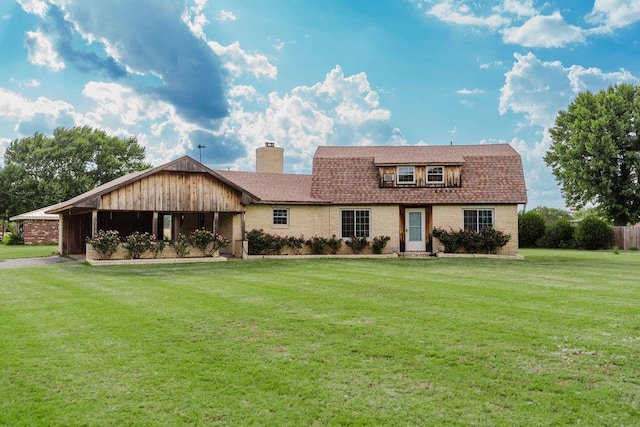 503 N Sheb Wooley Ave, Erick, OK 73645 - colonial inspired home featuring a front lawn, a chimney, roof with shingles, and brick siding