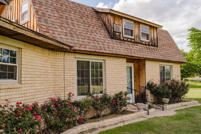 503 N Sheb Wooley Ave, Erick, OK 73645 - view of front facade featuring brick siding and roof with shingles
