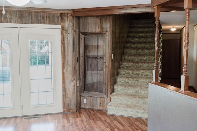 503 N Sheb Wooley Ave, Erick, OK 73645 - stairway featuring wood walls and wood finished floors