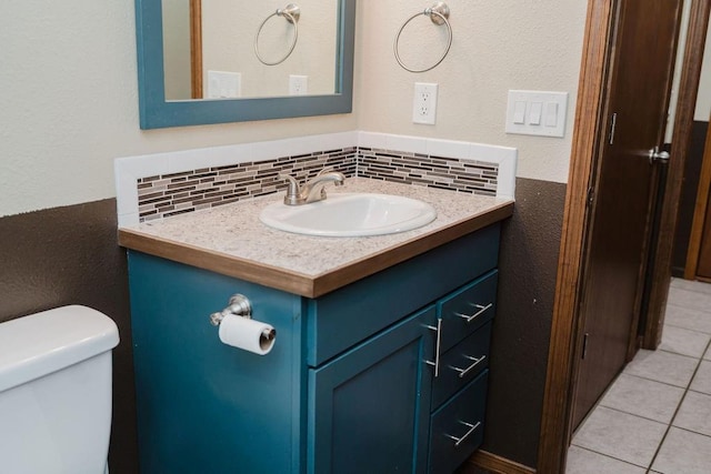 503 N Sheb Wooley Ave, Erick, OK 73645 - half bathroom featuring vanity, decorative backsplash, tile patterned flooring, and a textured wall