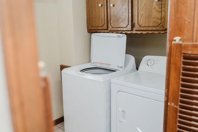 503 N Sheb Wooley Ave, Erick, OK 73645 - laundry room with separate washer and dryer, cabinet space, and light tile patterned flooring