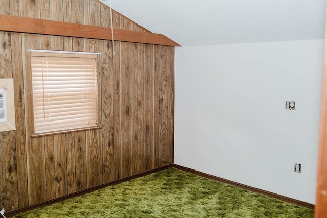 503 N Sheb Wooley Ave, Erick, OK 73645 - carpeted spare room with wood walls and lofted ceiling