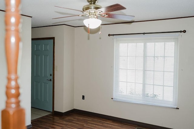 503 N Sheb Wooley Ave, Erick, OK 73645 - empty room with dark wood-style floors, ceiling fan, healthy amount of natural light, and ornamental molding
