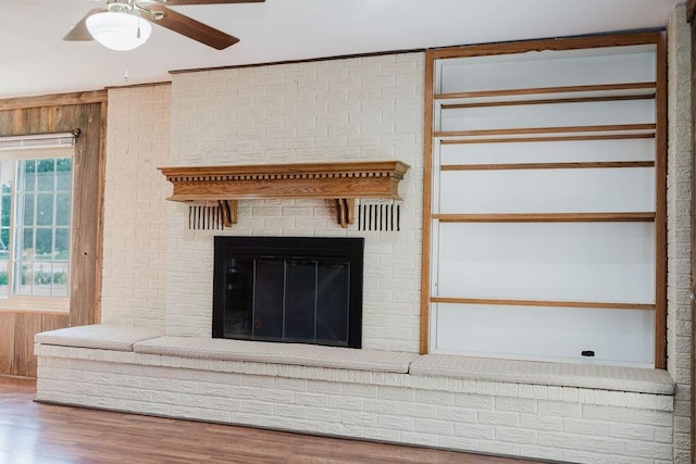 503 N Sheb Wooley Ave, Erick, OK 73645 - detailed view of wood finished floors, a fireplace, and a ceiling fan