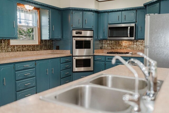 503 N Sheb Wooley Ave, Erick, OK 73645 - kitchen featuring appliances with stainless steel finishes, light countertops, and tasteful backsplash