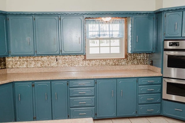503 N Sheb Wooley Ave, Erick, OK 73645 - kitchen featuring stainless steel double oven, light countertops, decorative backsplash, and light tile patterned floors