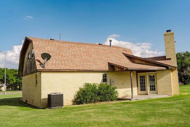 503 N Sheb Wooley Ave, Erick, OK 73645 - rear view of house with brick siding, a yard, a chimney, and a patio area