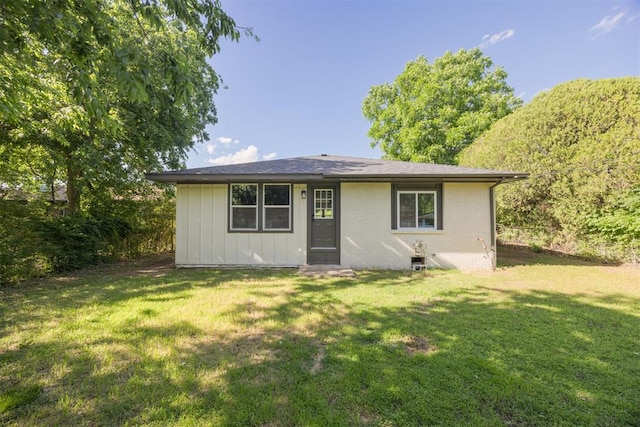 2020 Hasley Dr, The Village, OK 73120 - view of front of house featuring brick siding, a front lawn, and board and batten siding