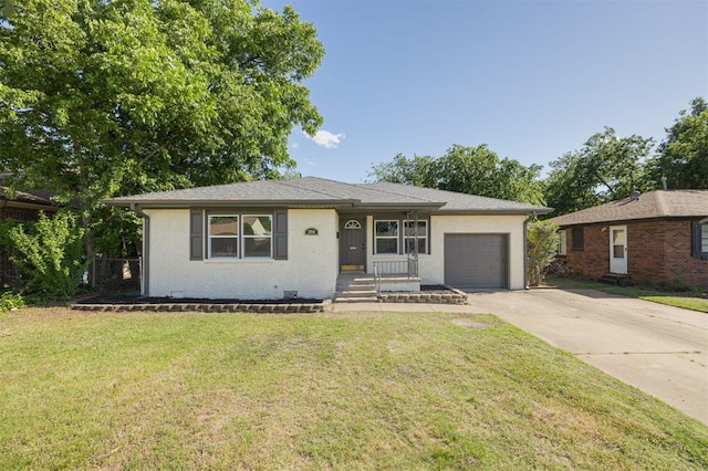 2020 Hasley Dr, The Village, OK 73120 - view of front facade with concrete driveway, a garage, a front lawn, and brick siding