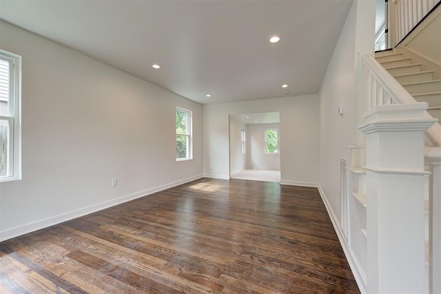 2836 NW 43rd St, Oklahoma City, OK 73112 - unfurnished living room featuring healthy amount of natural light, wood finished floors, recessed lighting, and stairway